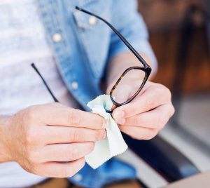 cleaning glasses with shirt